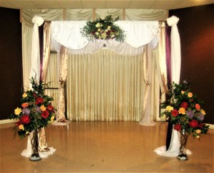 Altar / Chuppah Decorated with Swag and Large Rose Vases